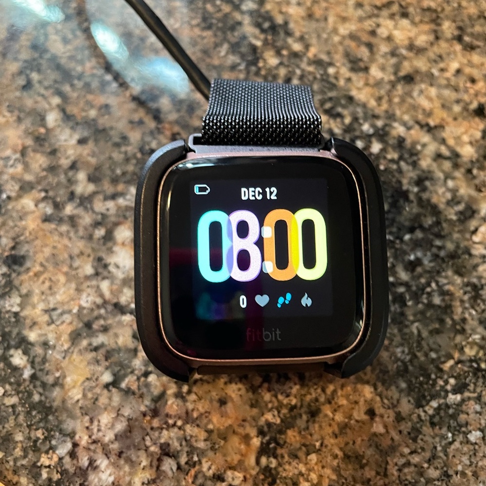 Rose gold fit bit versa. Used for a week. Comes with charger.